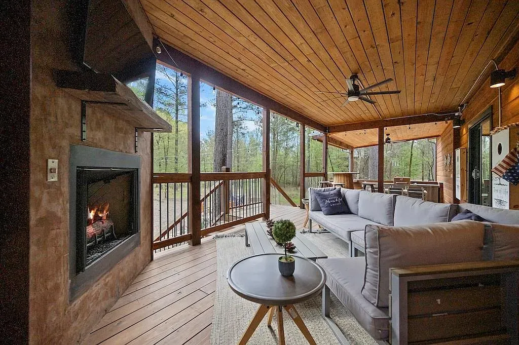 Covered outdoor room with a warm wood ceiling and big nature views.