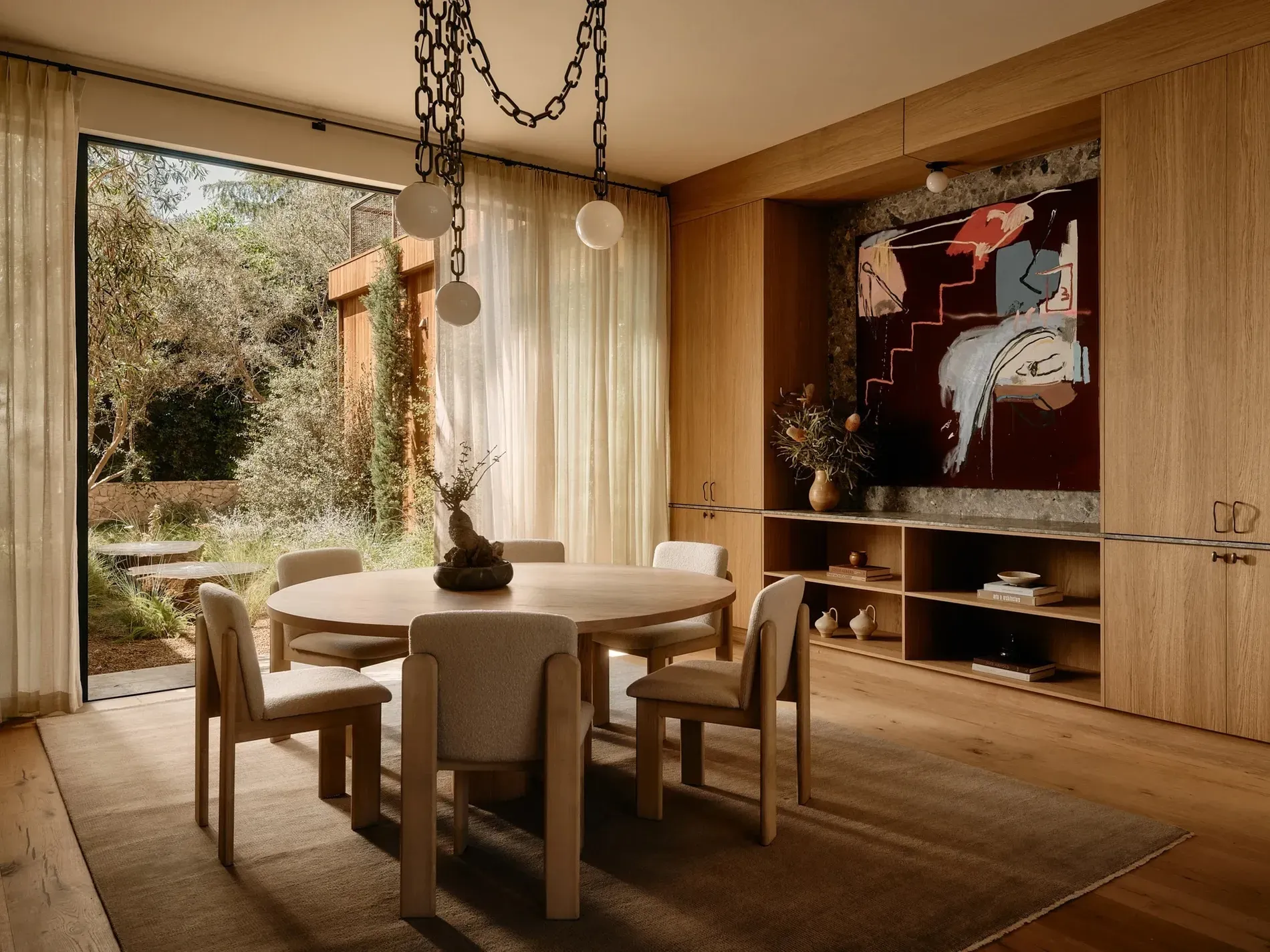 Round table moment — four marshmallow chairs. Looks lingering dinners would happen.