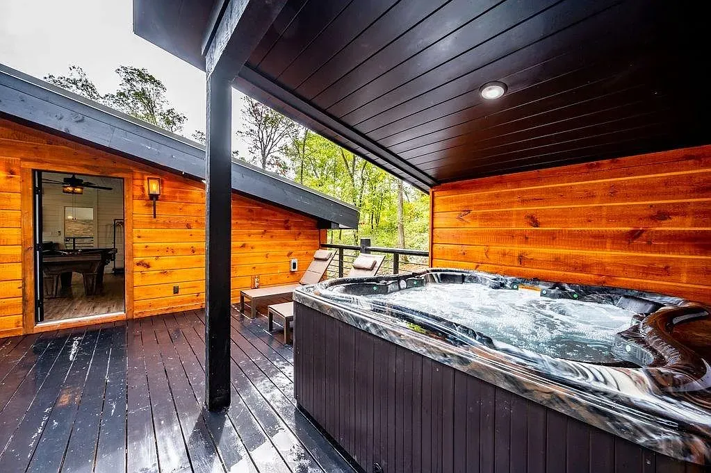 Hot tub under cover. All wood everything, dark ceiling, instant cabin spa.