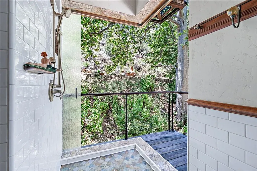 Open shower with white subway all the way up. Indoor-outdoor vibes.