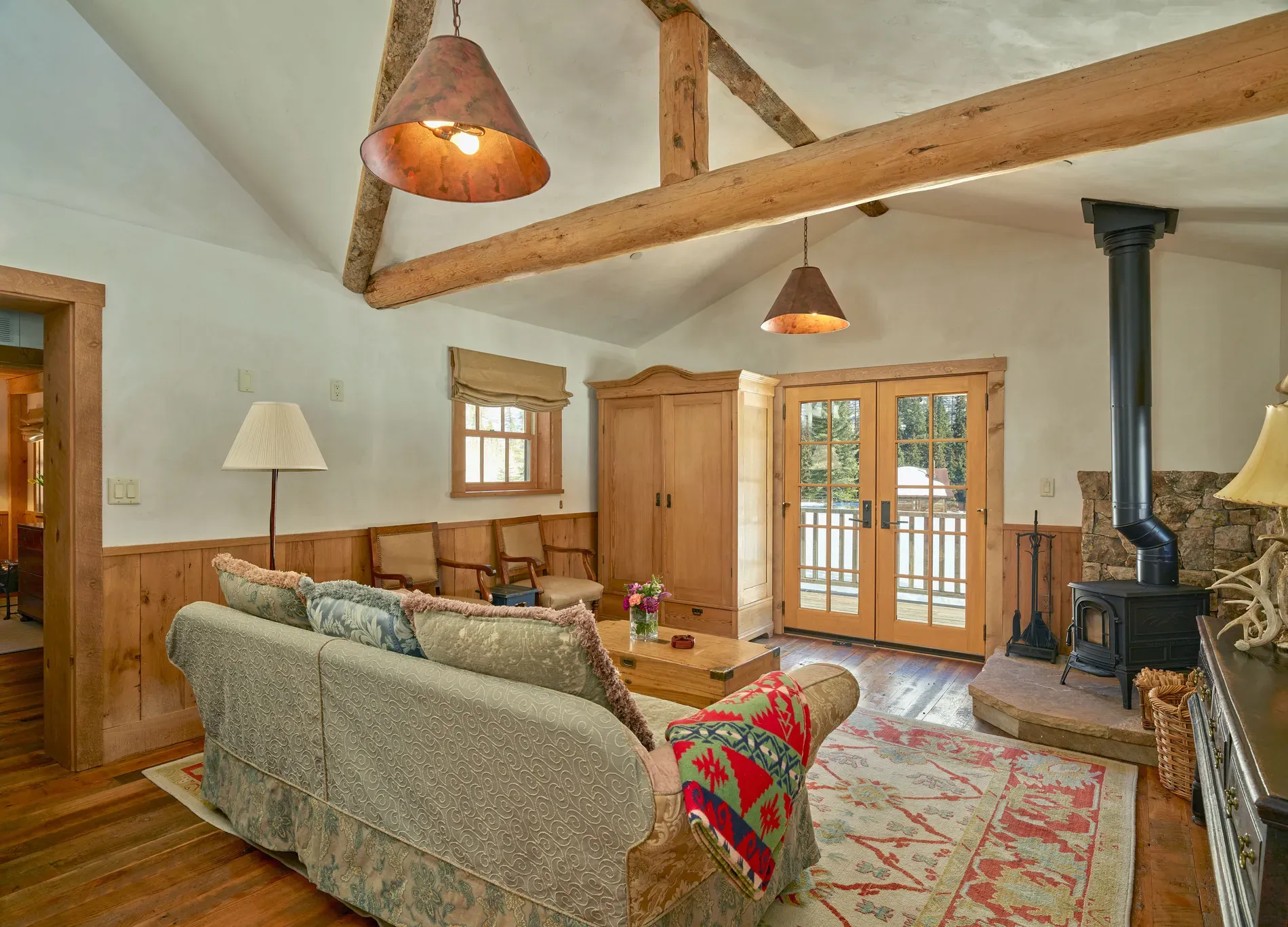 Living room goes vaulted and neutral. Plush sofa, fireside nap guaranteed.