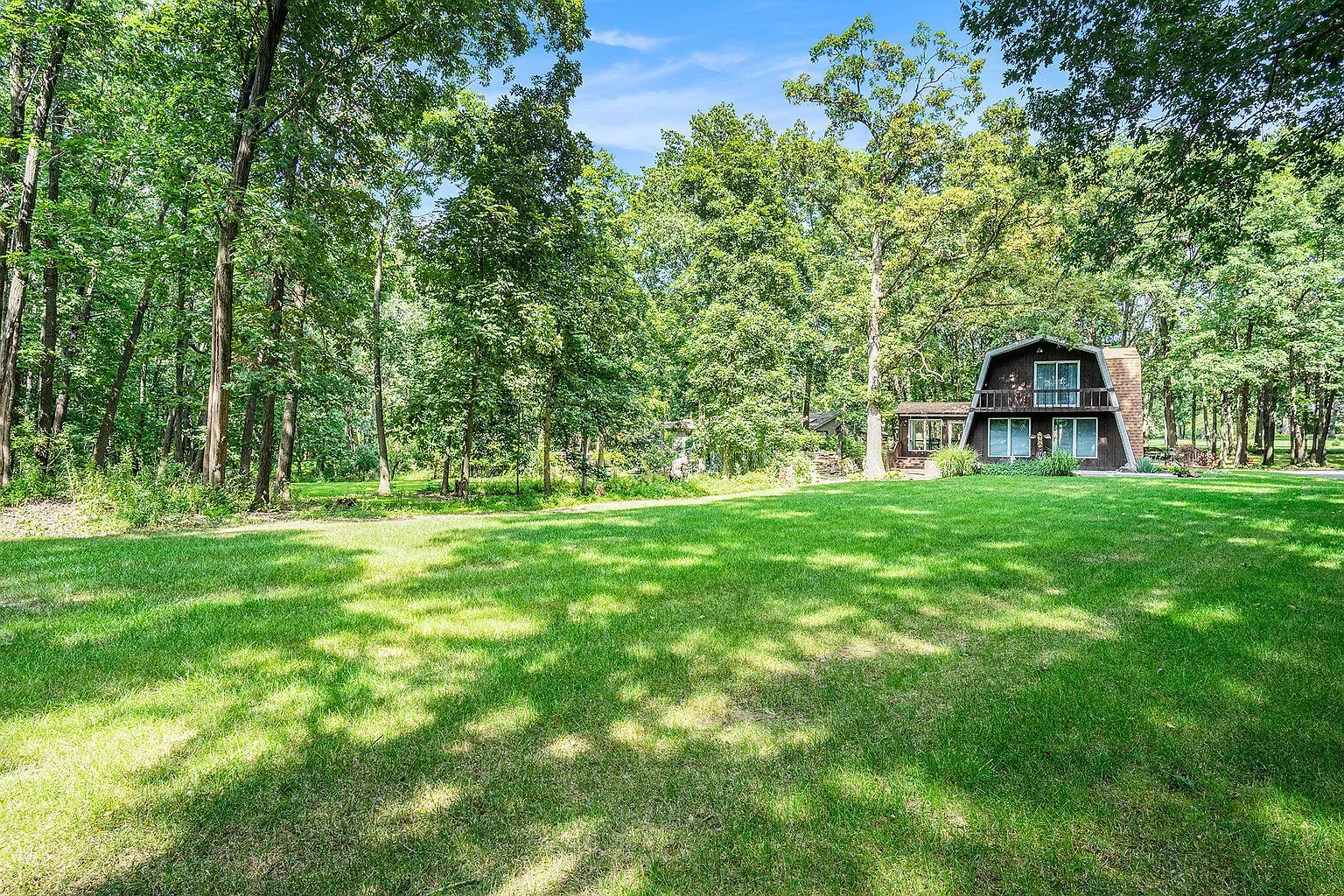 Tucked in the woods with big windows. Privacy without losing light.