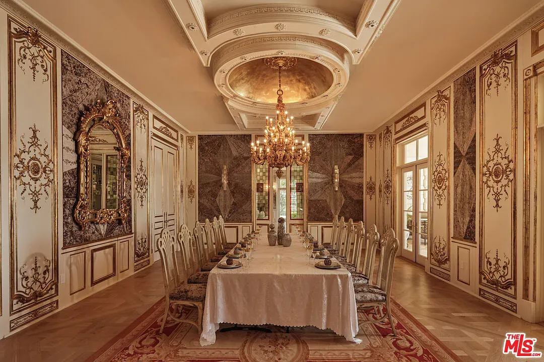 Dining room with damask walls and heavy moldings. Feels museum-level formal.