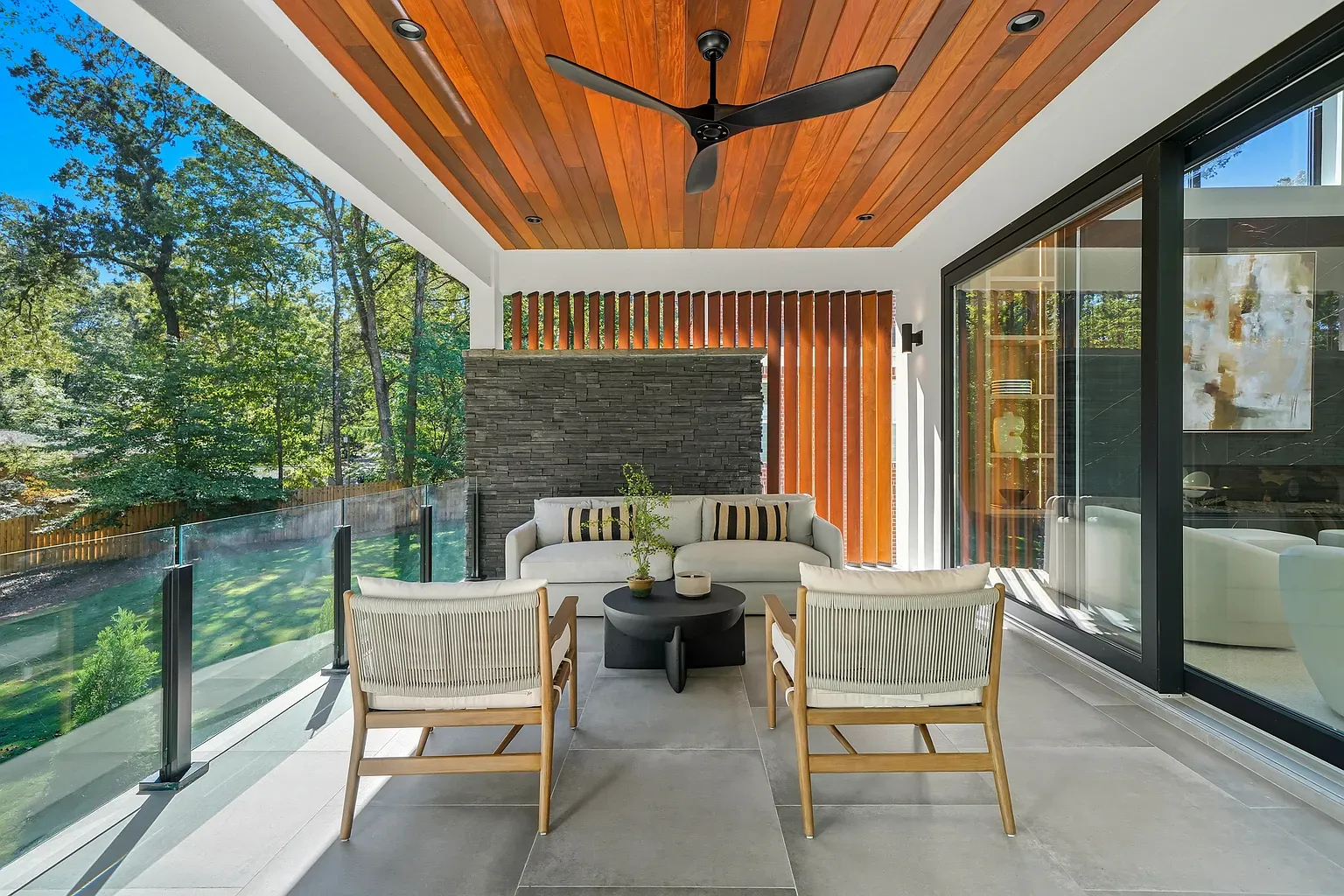 Covered patio with that cedar ceiling is a yes. Glass walls everywhere.
