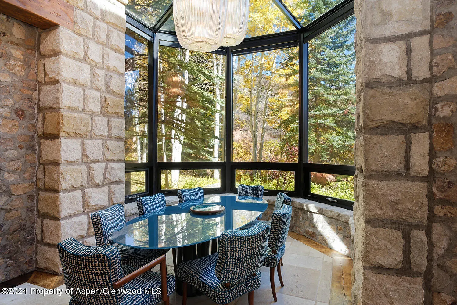 Breakfast nook in a glass corner. Forest views doing all the talking.