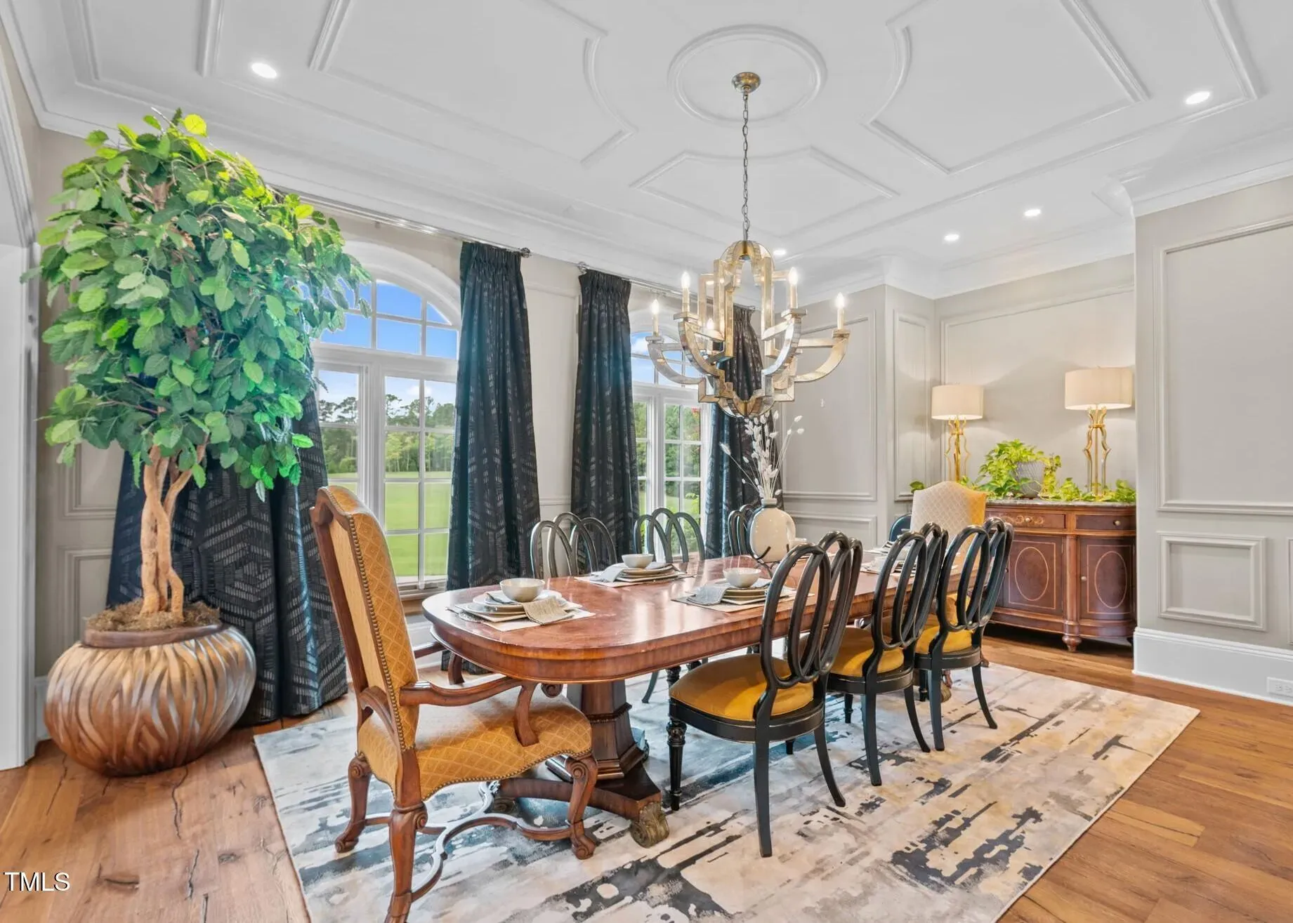 Dining room glow-up—carved table, eight chairs. Not sure about the chandelier.