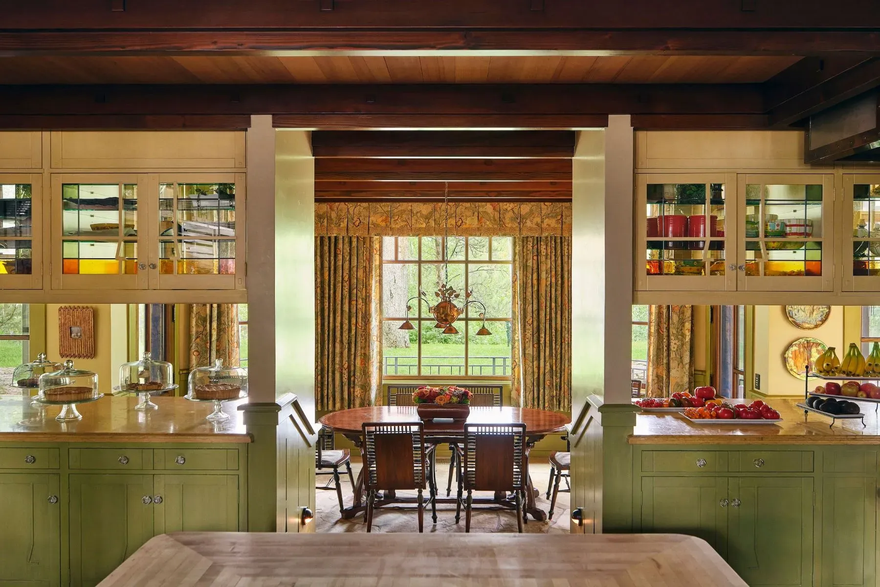 Green cabinets with wood accents. Cozy without trying too hard.