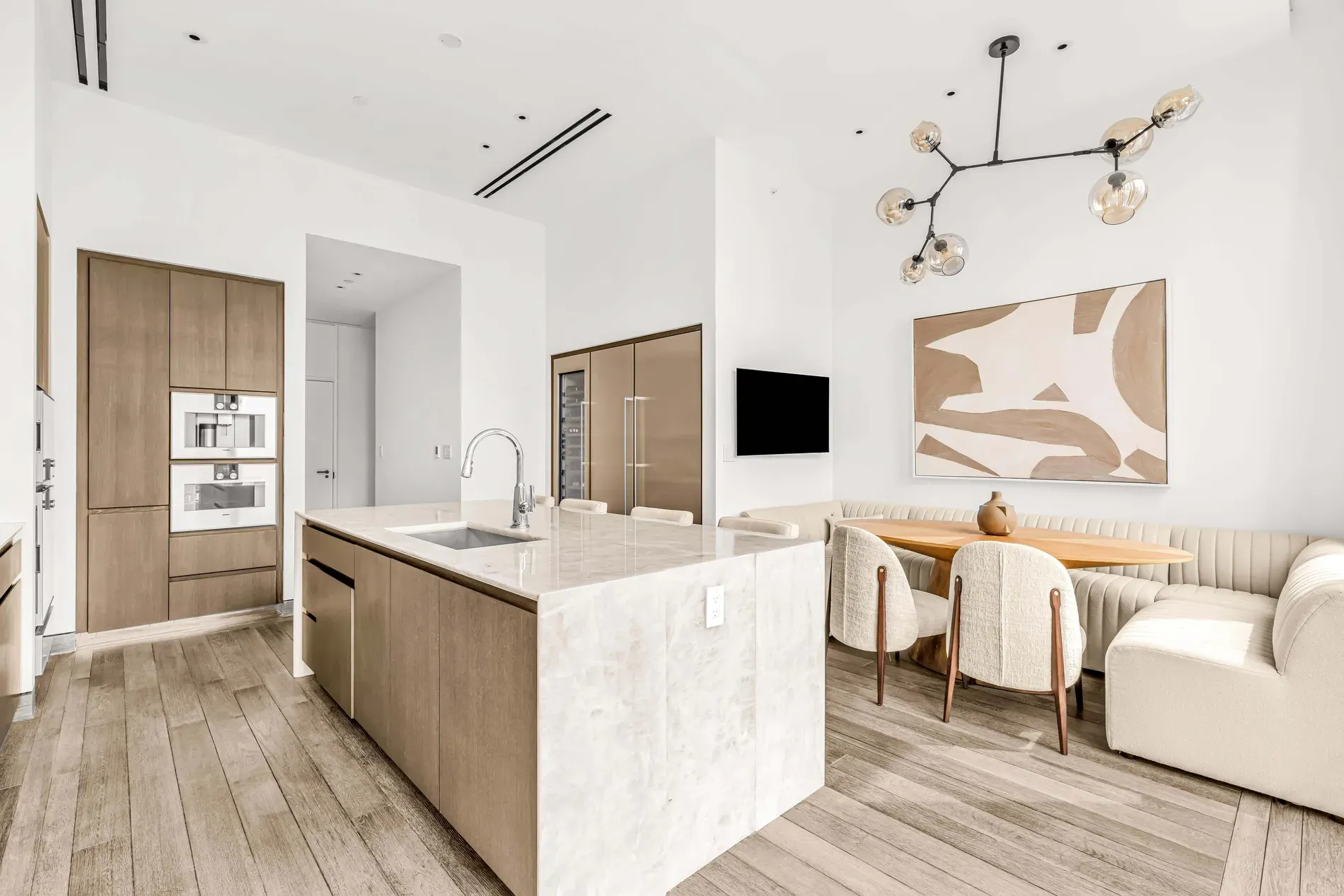 Here's the kitchen — chunky marble island, warm wood cabinets, very staging-friendly.