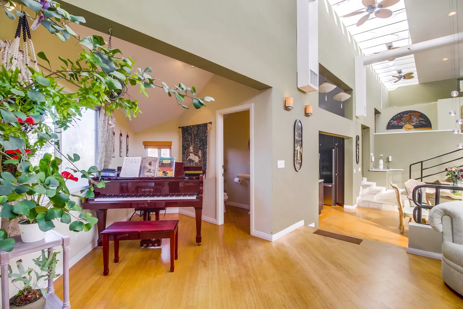 Olive walls and a big skylight. Warm, plant-friendly energy.