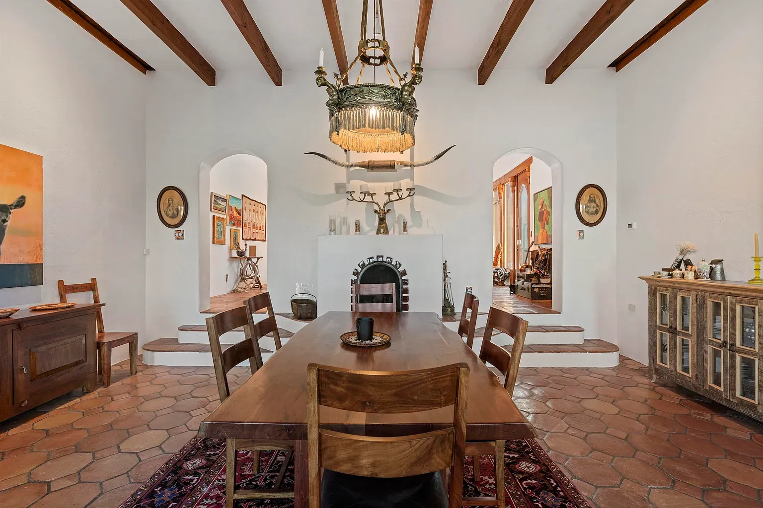 Chunky table, honest chairs, lots of light. Dinner would actually linger here.