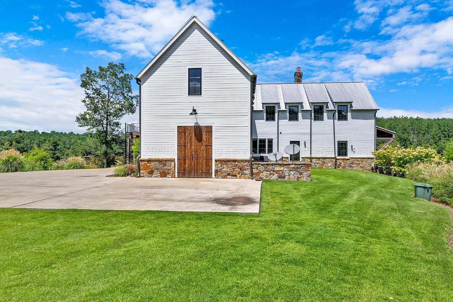 Classic white farmhouse exterior, board-and-batten everywhere. Clean lines but still country.