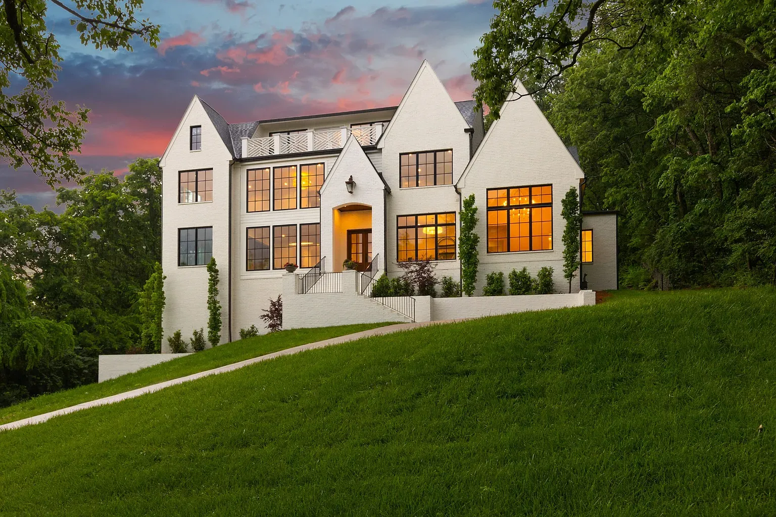Sharp white gables for days. Modern farmhouse but cleaner.