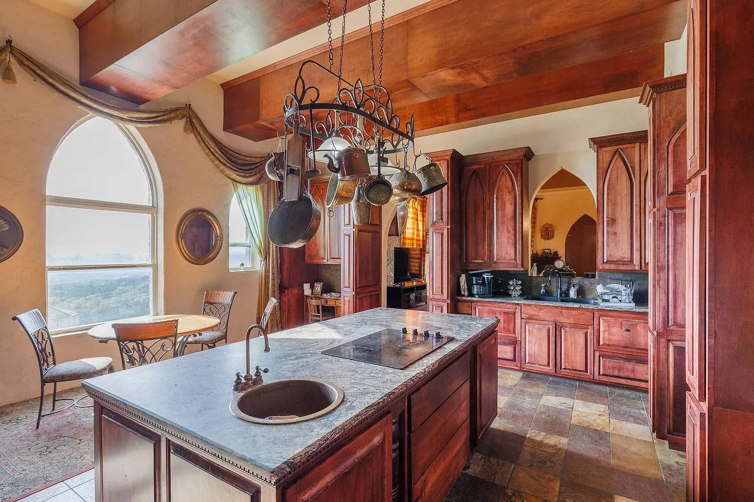 Ceiling-height cabinets and those arched windows. Feels grand but still workable.