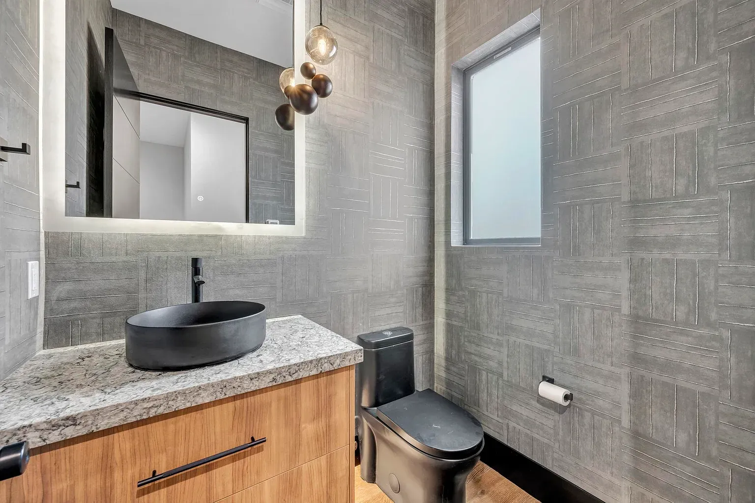 Textured walls and a double vanity—feels hotel, in a good way.
