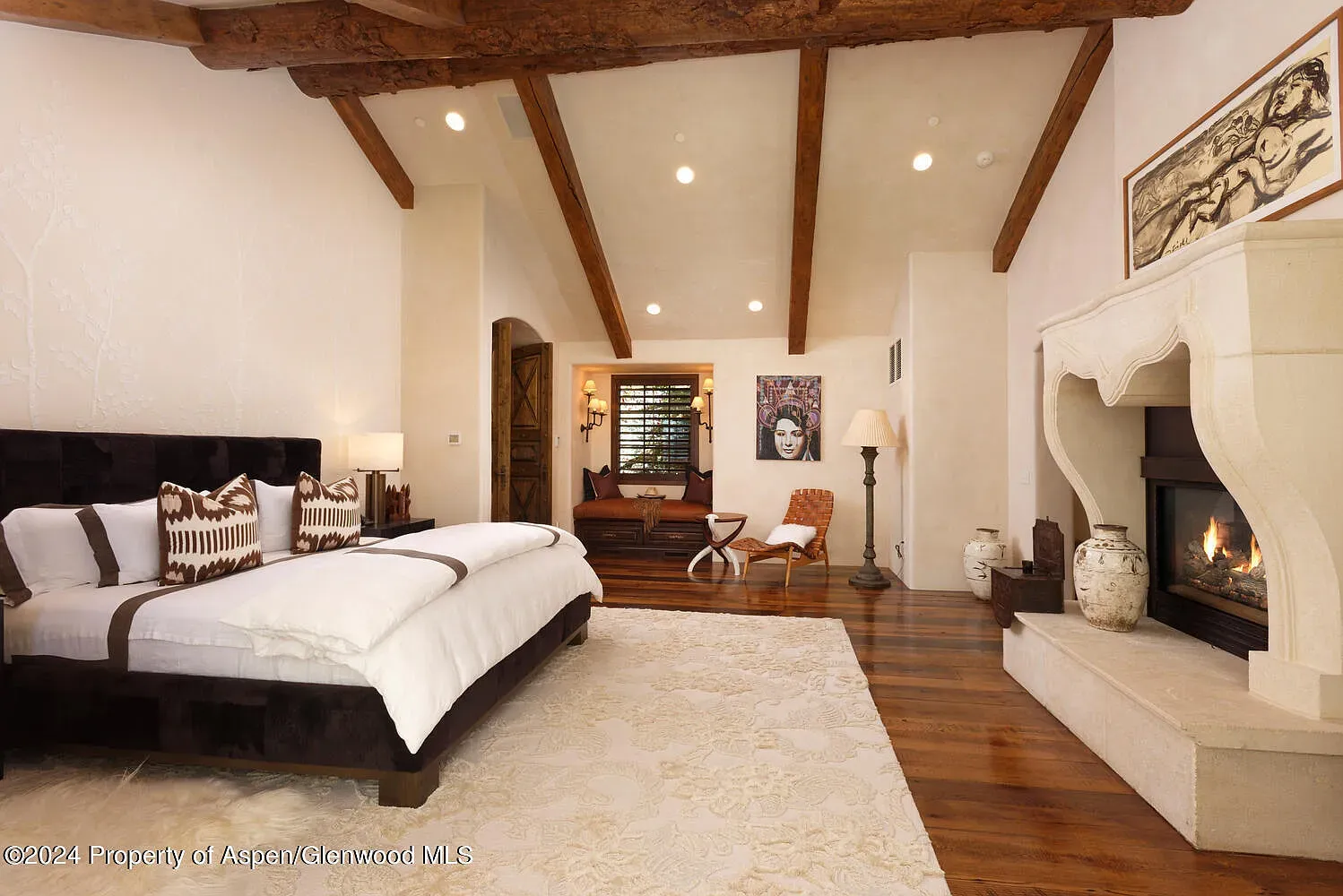 Simple, calm bedroom. Sloped ceiling with beams makes it feel taller.