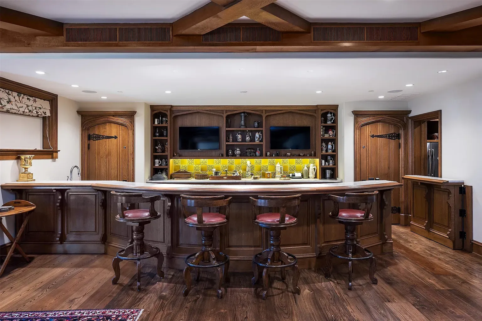 Curved bar moment. Dark wood, shiny top, definitely a host-the-game spot.