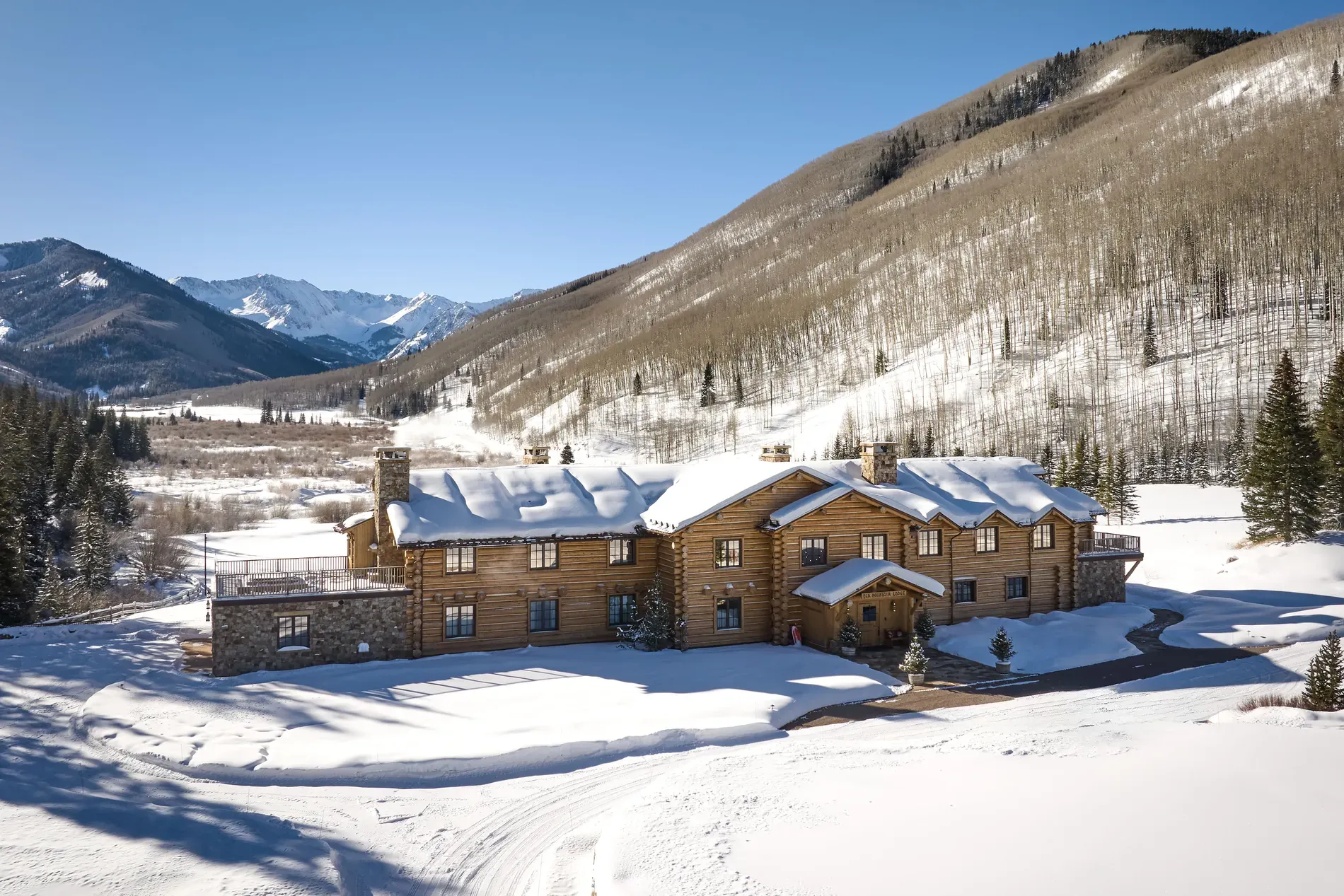 Back outside, golden wood and stone chimney. From this angle, it glows.