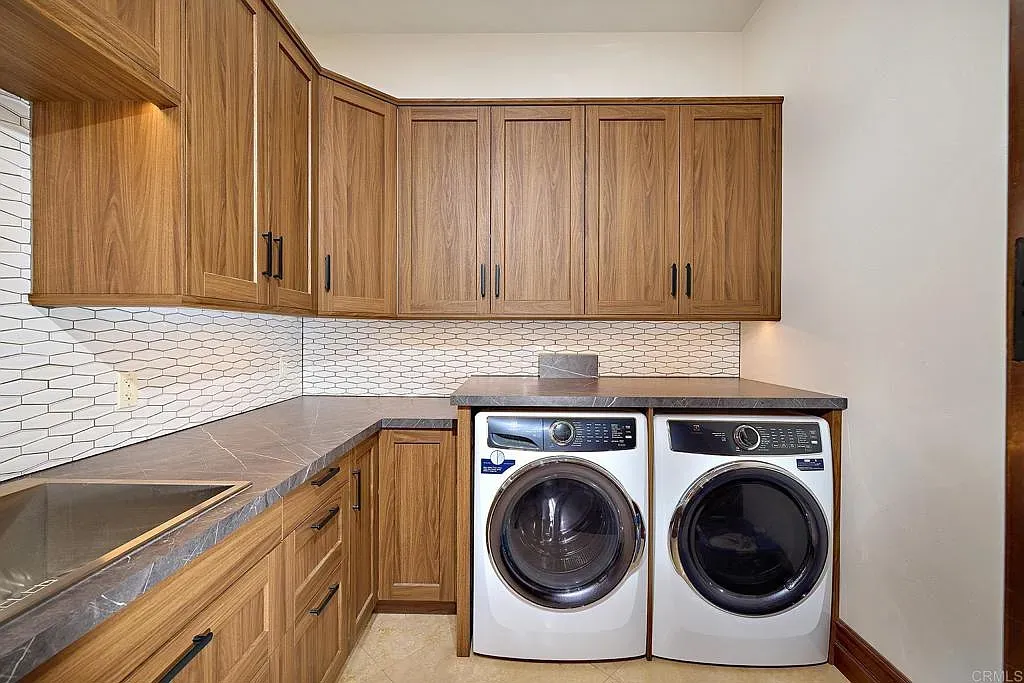 Laundry room with tons of warm cabinets. Folding might not be the worst here.