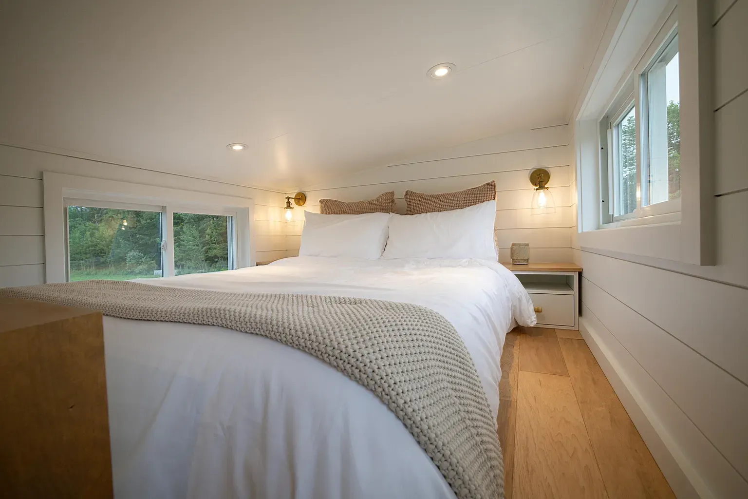Loft bedroom with trees out both windows. Looks peaceful up here.