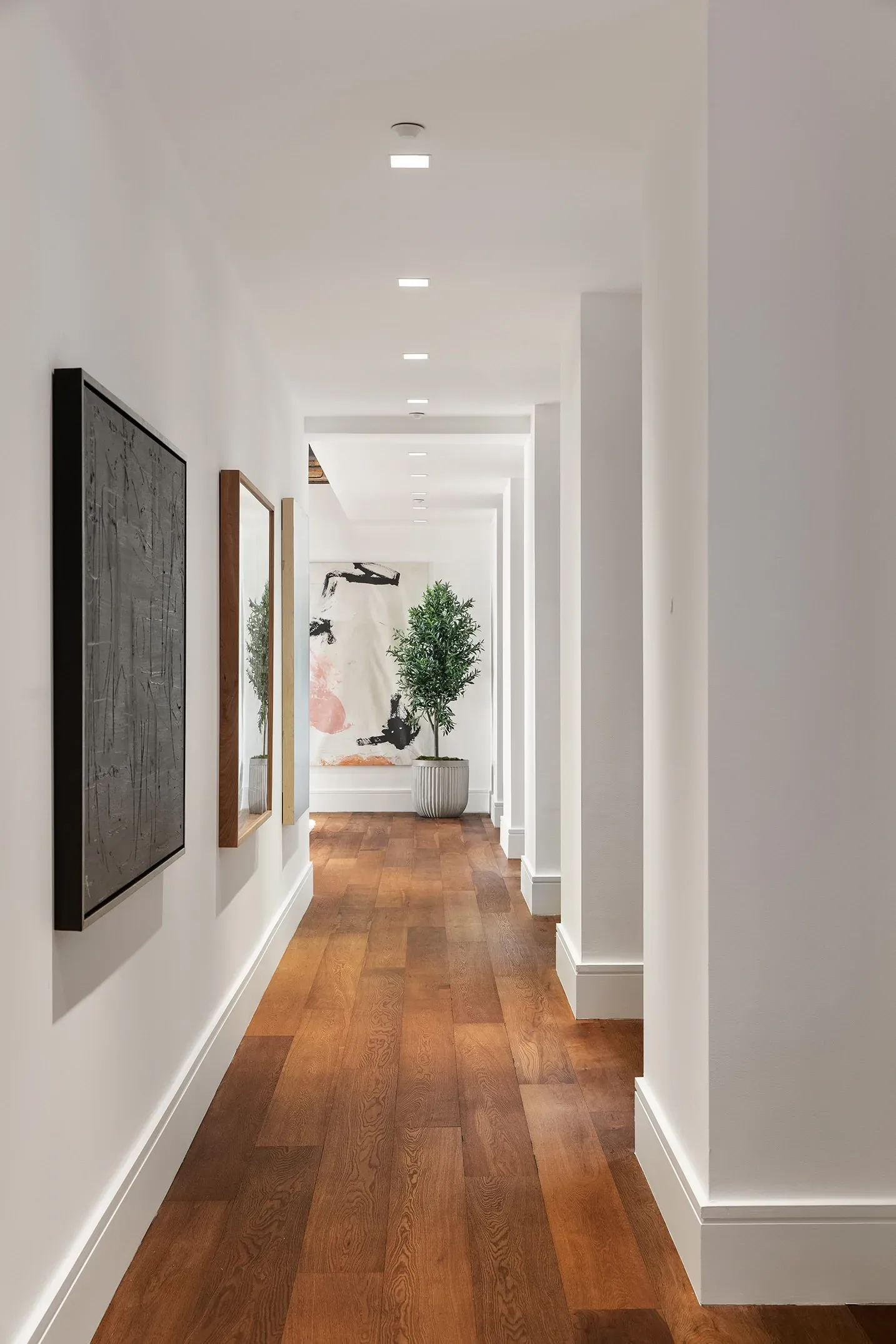 Anyone know why they did this? Bare walls, then warm wood floors save it.