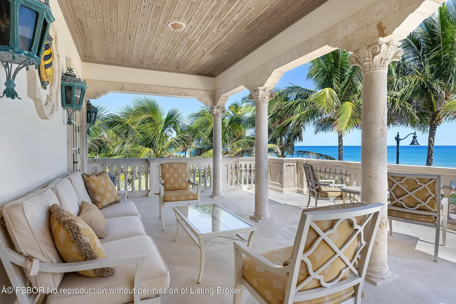 Back outside—shaded veranda, stone floors, ocean soundtrack. Ceiling wood looks perfect.