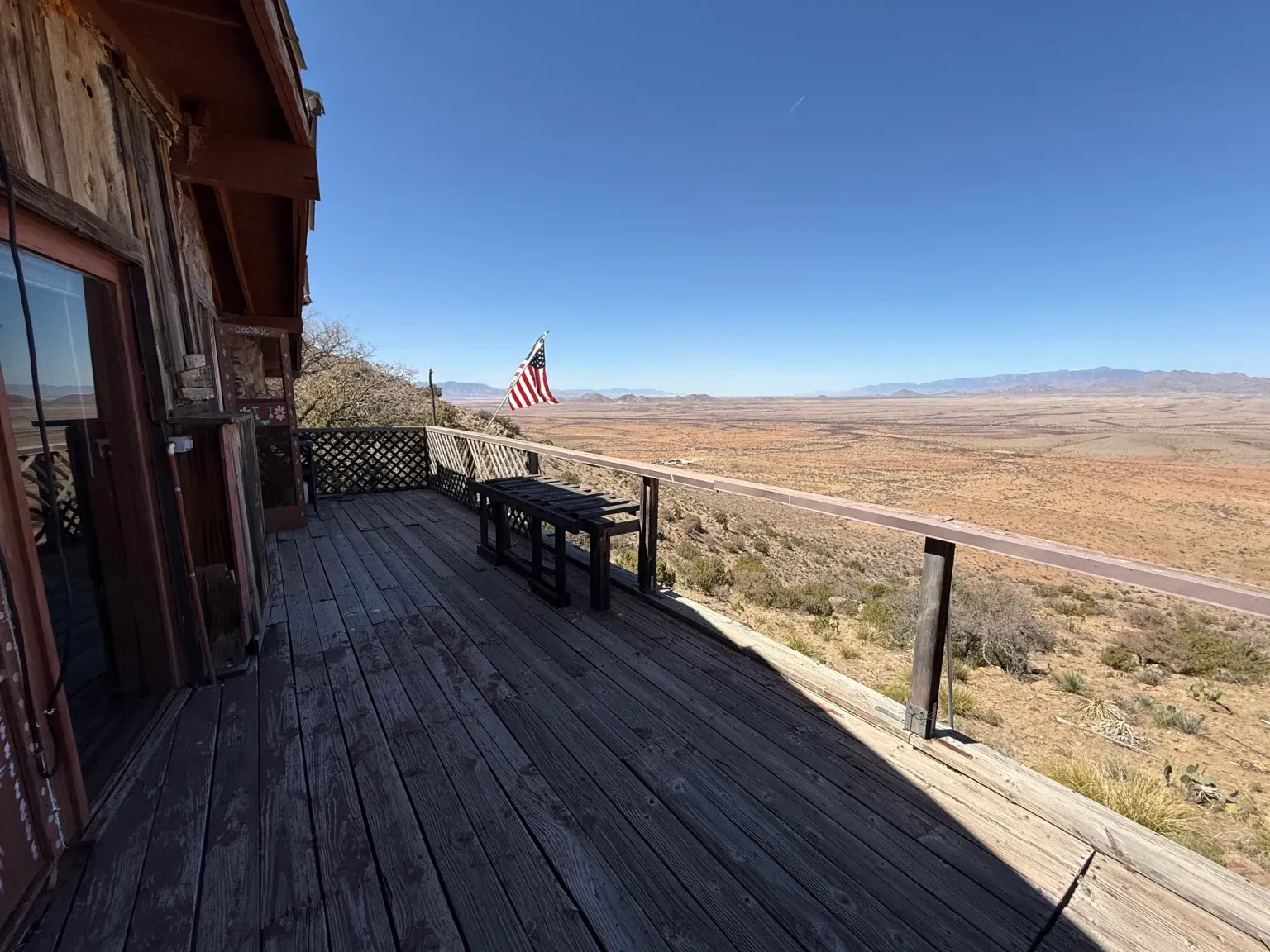Weathered deck looking out over pure desert. Morning coffee spot sorted.