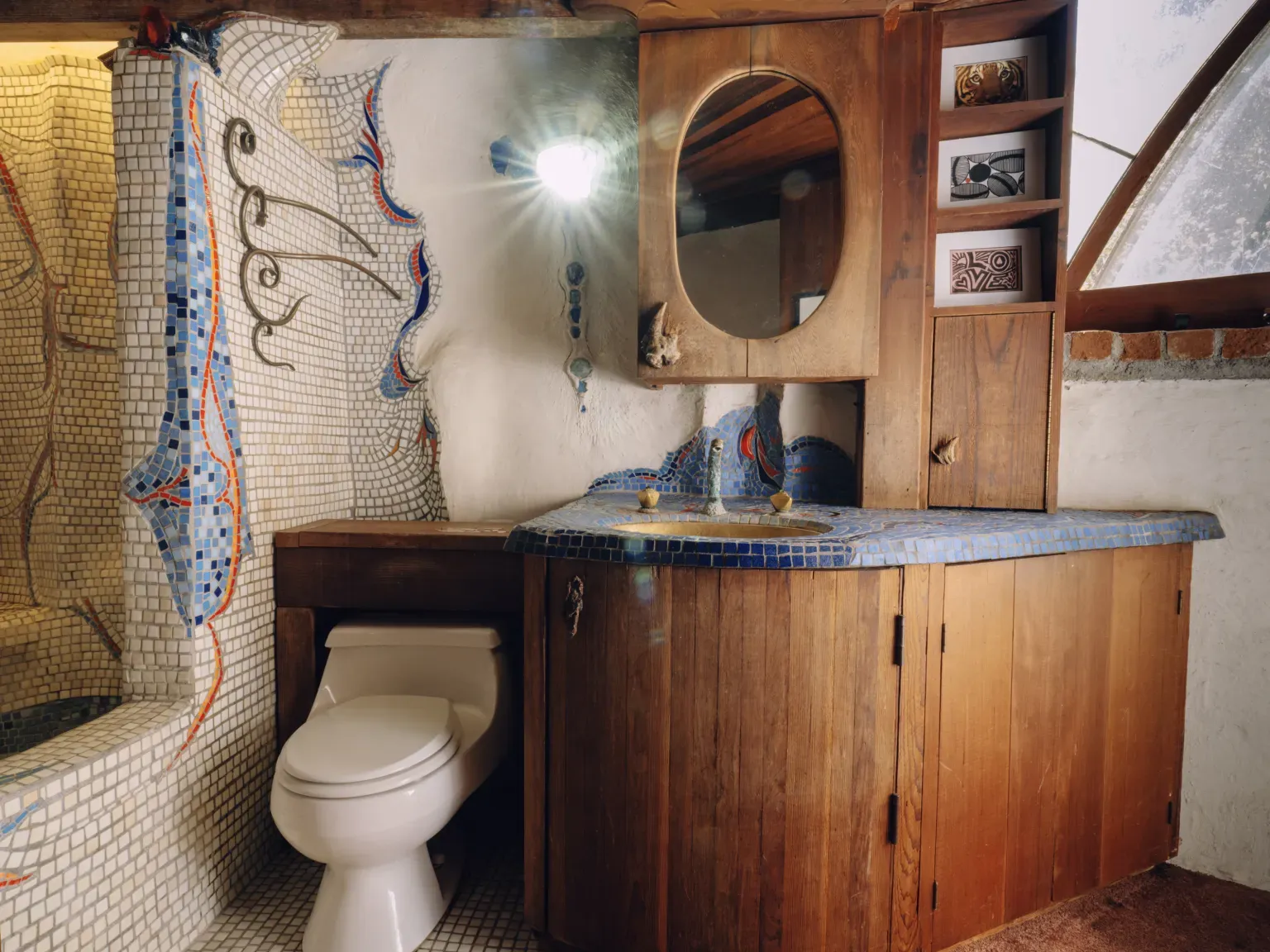 Blue tile around the sink pops against all the warm wood.
