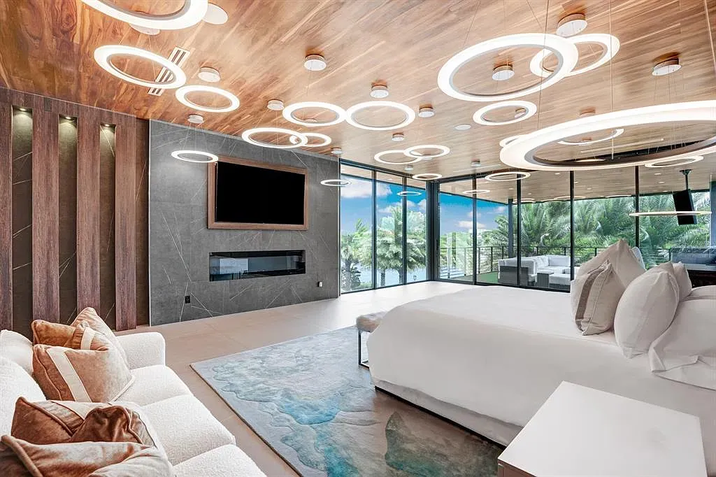 Bedroom with that circular light ceiling. Warm glow, sleek everything, looks quiet.