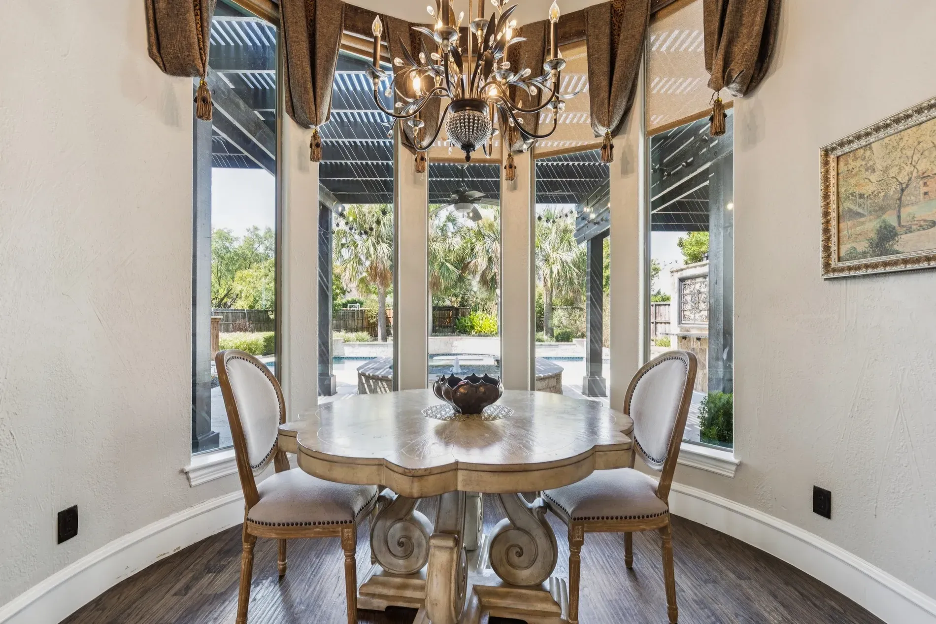 Cute round table with fancy scroll legs. Cream walls keep it light.
