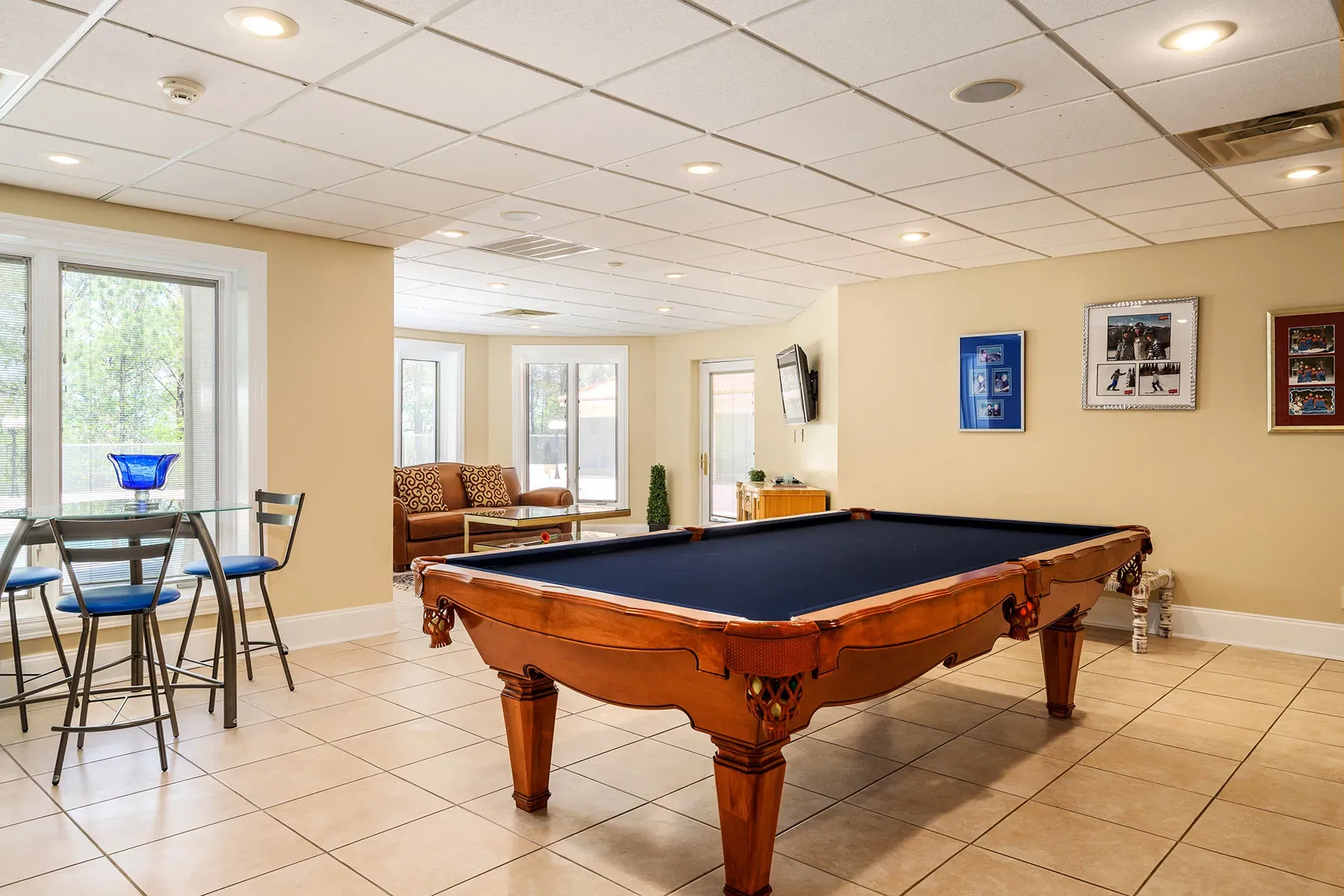 Game room with a mahogany table, navy felt. Classic bar energy.