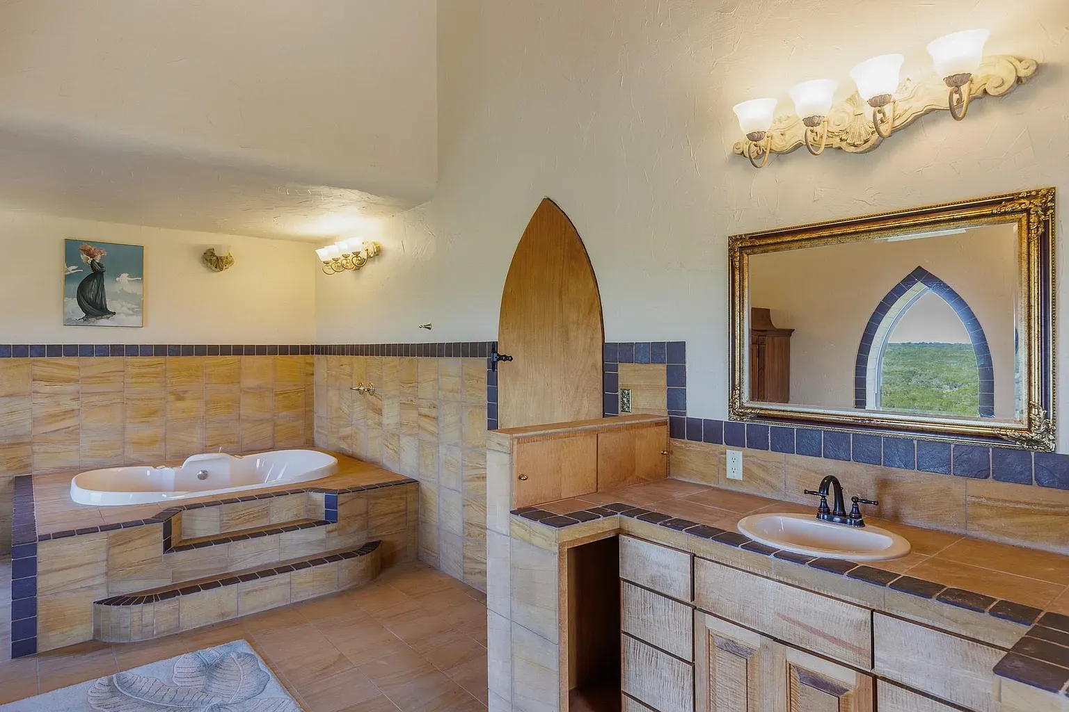 Bathroom does the arched thing too. Warm tiles, pretty light, view framed nicely.