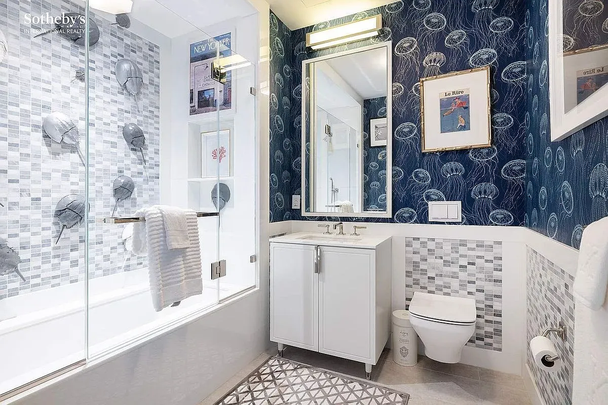 Chic bathroom, glass shower box, watery blues everywhere. Cute, maybe a tad theme-y?