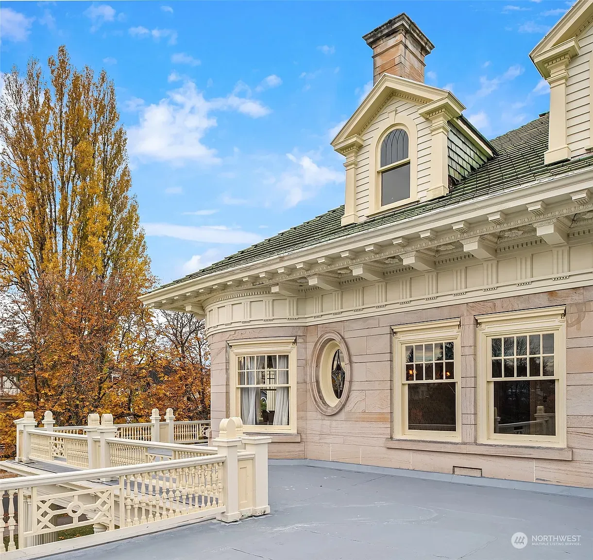 Rooftop terrace feels fancy and calm. Pale stone, classic-meets-modern lines.