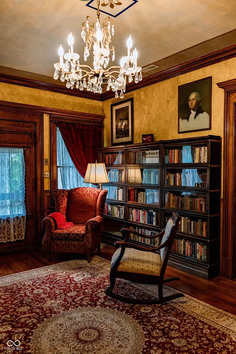Library time. Wood paneling, soft gold walls, and probably a secret door somewhere.