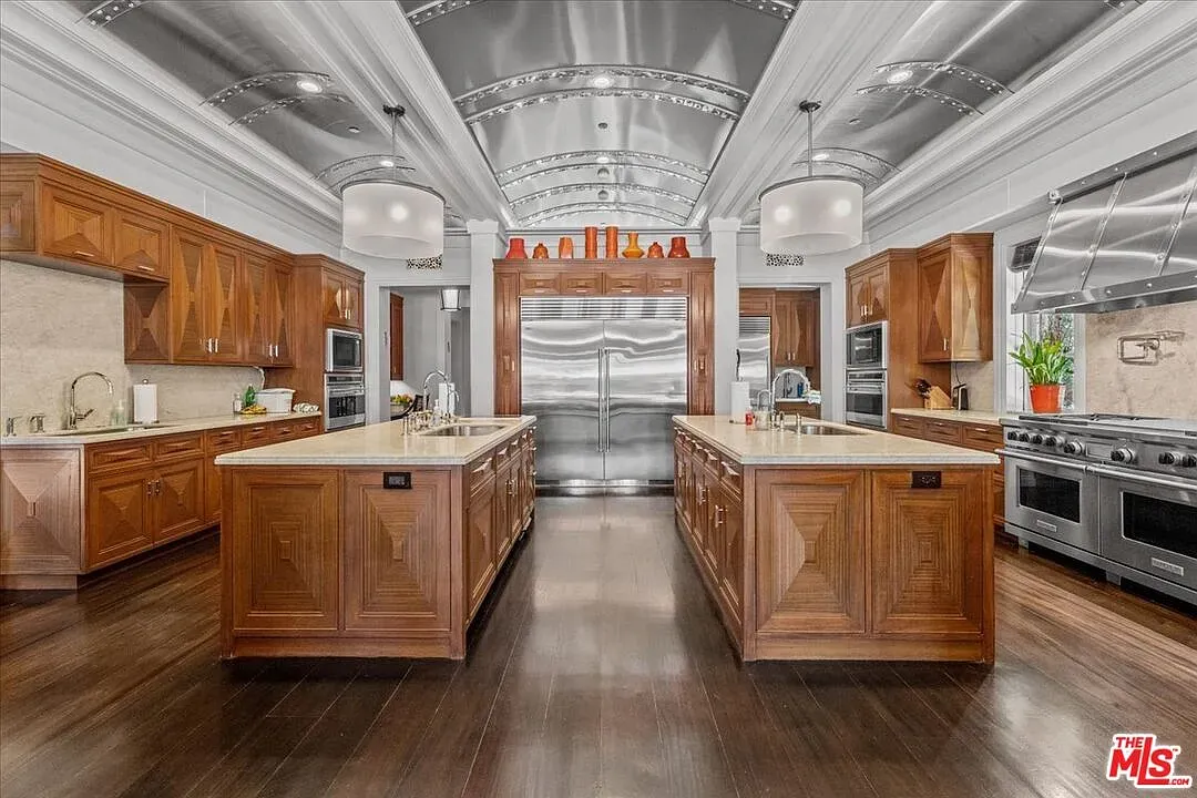 Dark wood kitchen with light counters. Big, polished, very grown-up.