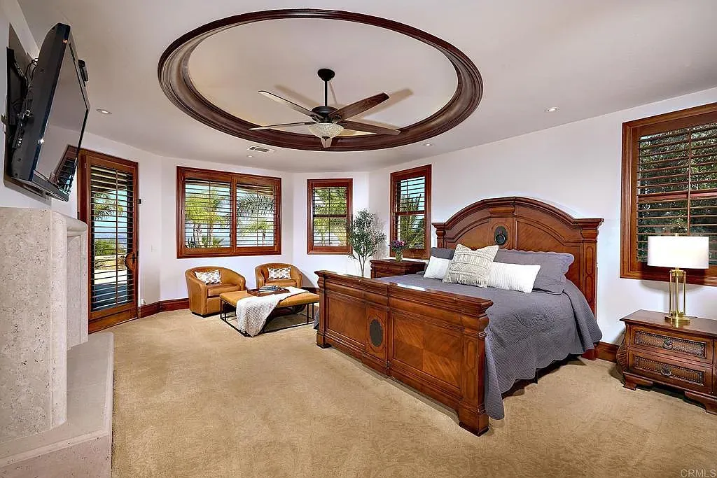 The bedroom goes full dark wood, huge carved bed that actually looks comfy.