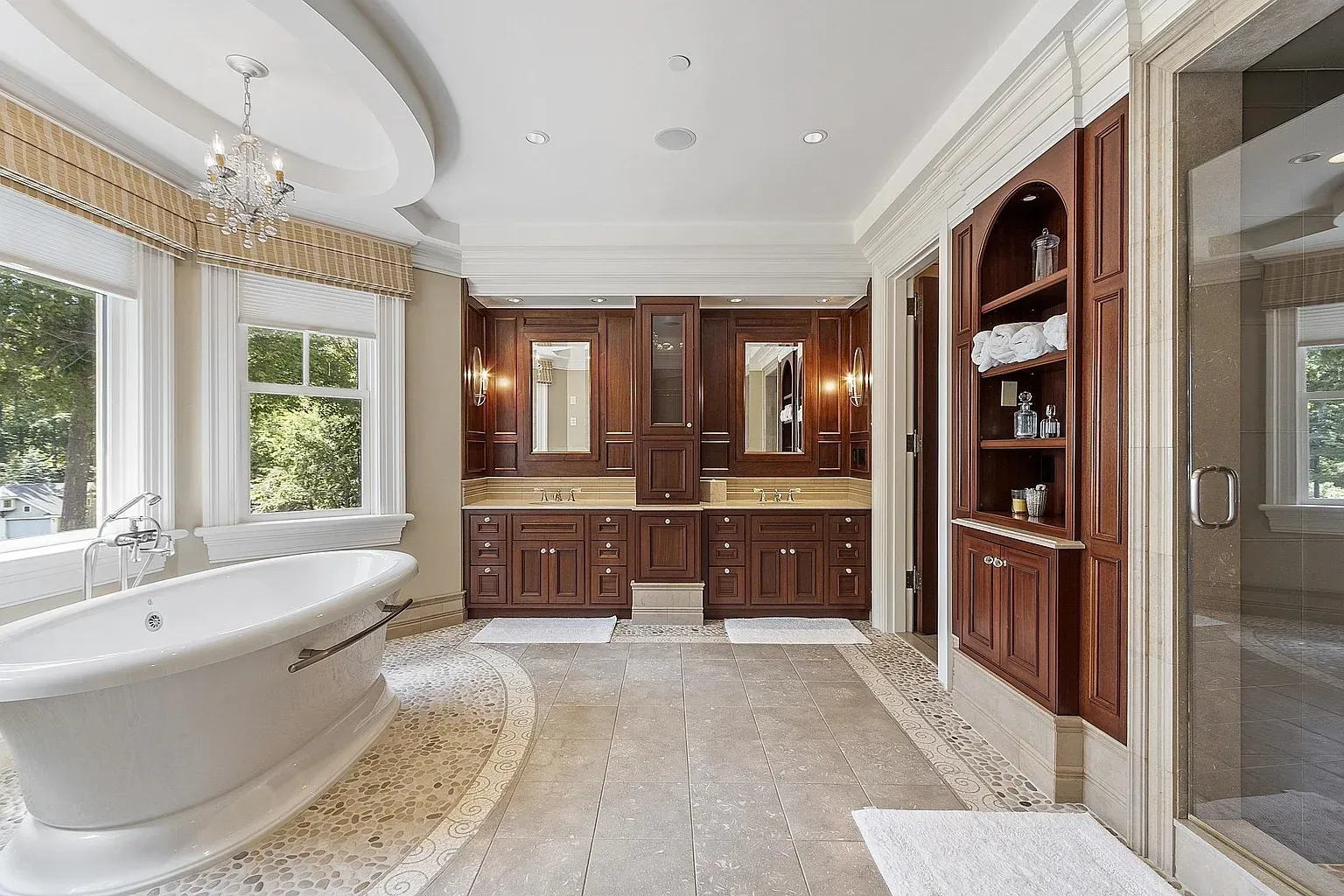 Freestanding tub plus mahogany vanity feels fancy without shouting.