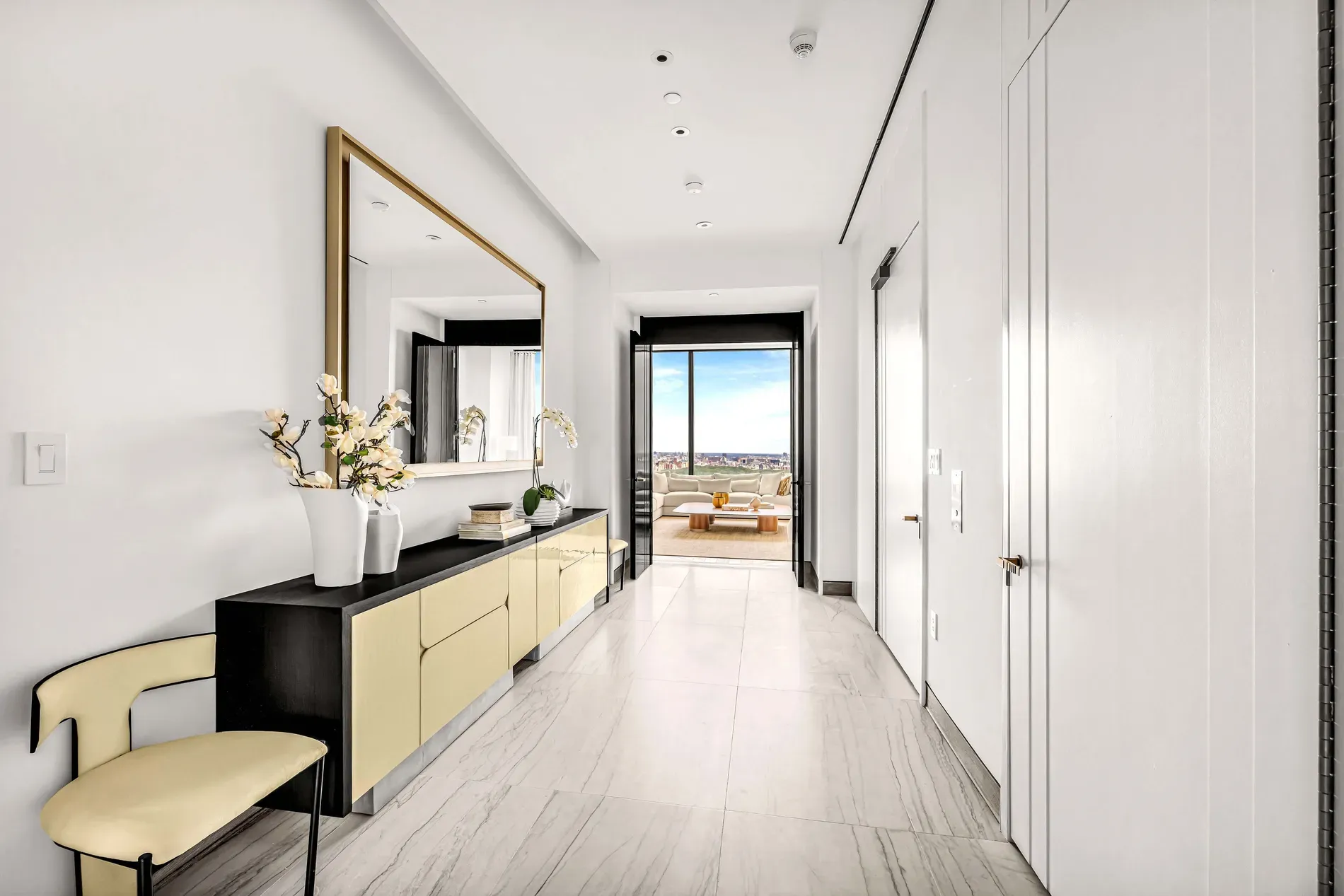 Hallway flex — white walls, glossy marble, that long two-tone console.