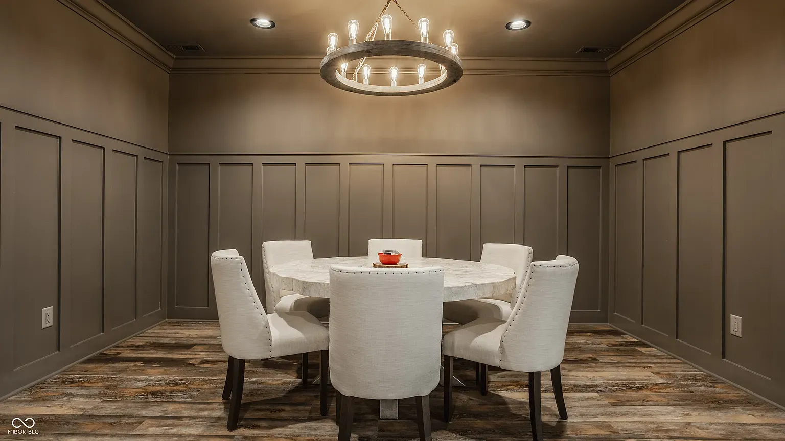 Small dinner spot with marble table and wrapped walls. Night-in territory.