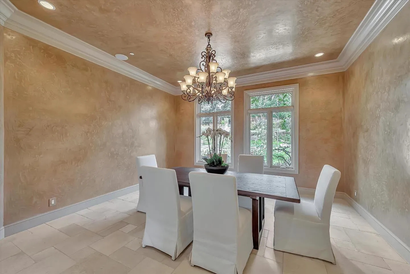 Warm dining room with that soft gold plaster. Candlelight would look amazing here.