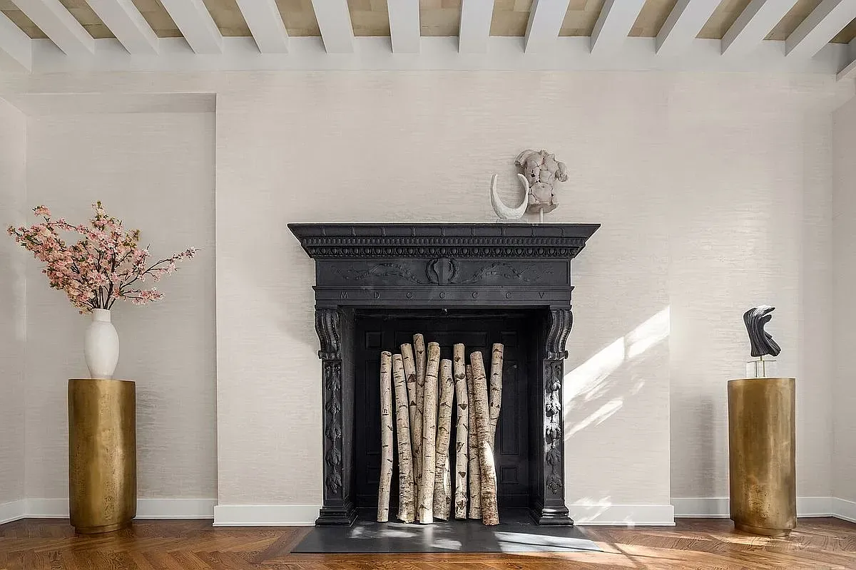 Black carved fireplace with art where flames go. Anyone know why they did this?