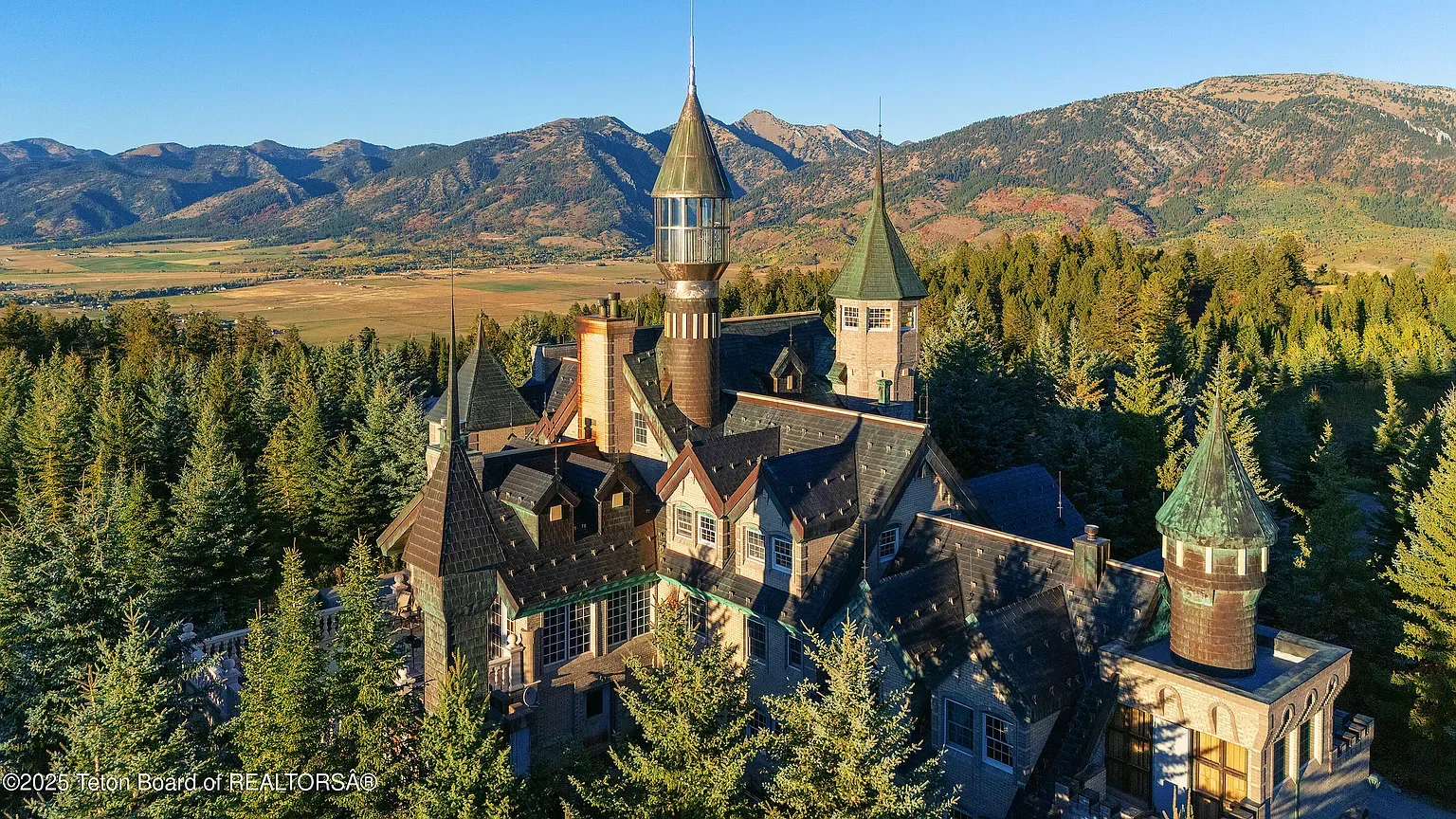 Storybook mountain exterior—dark shingles and stone. Kinda obsessed with the rooflines.