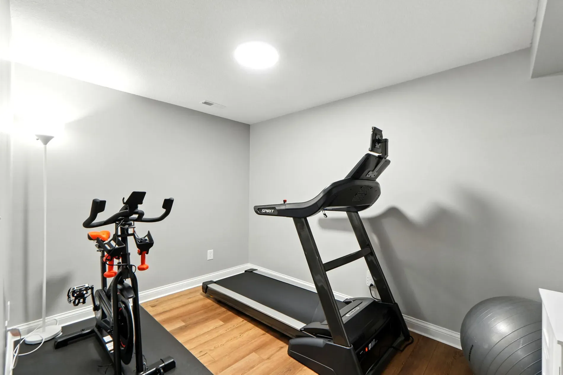 Little gym corner — enough for a bike and some dumbbells. Works.