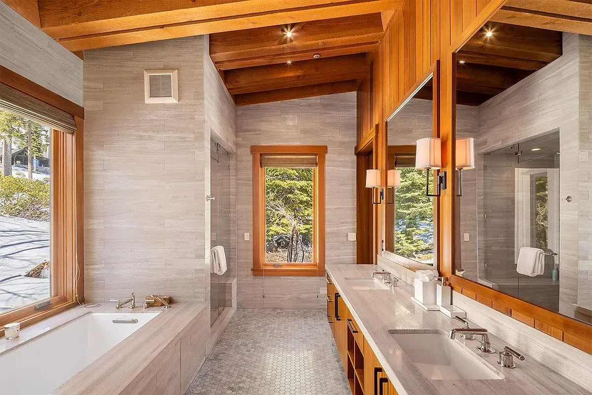 Exposed wooden beams over a calm, modern bathroom. Spa energy without trying.