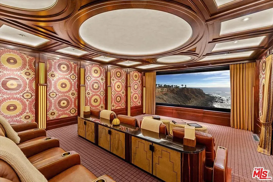 Art Deco theater with wood paneling and a moody ceiling. Movie night flex.