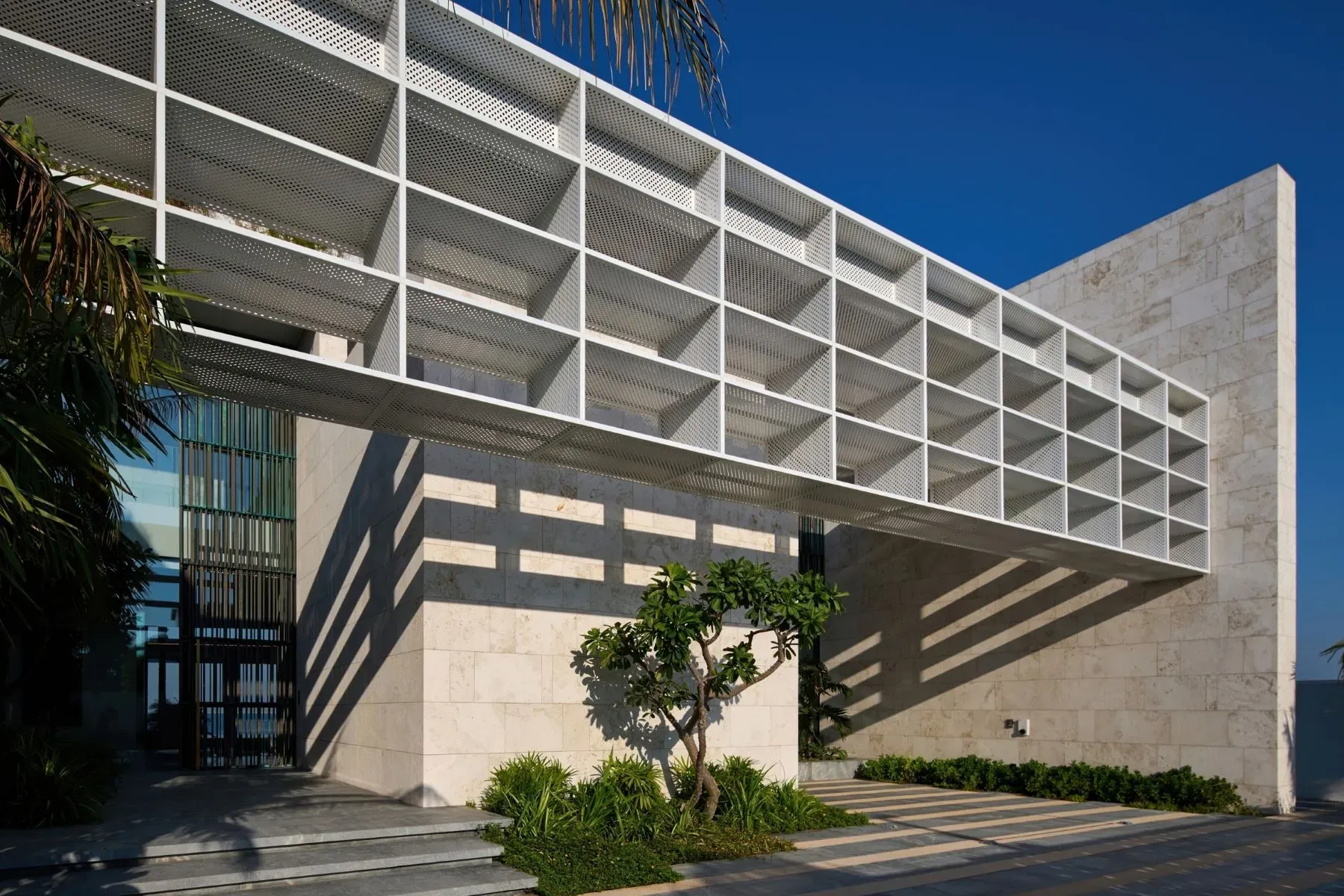 That white grid over the facade is wild. Light patterns everywhere.