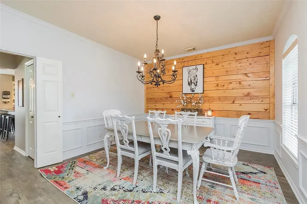 Long gray dining table with mixed chairs. Feels ready for a big dinner.