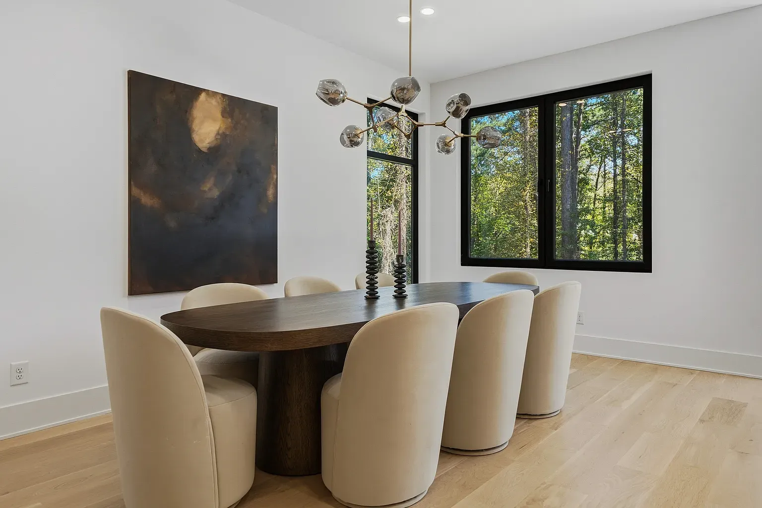 Dining room with the oval table looks legit. Dark wood against light walls.