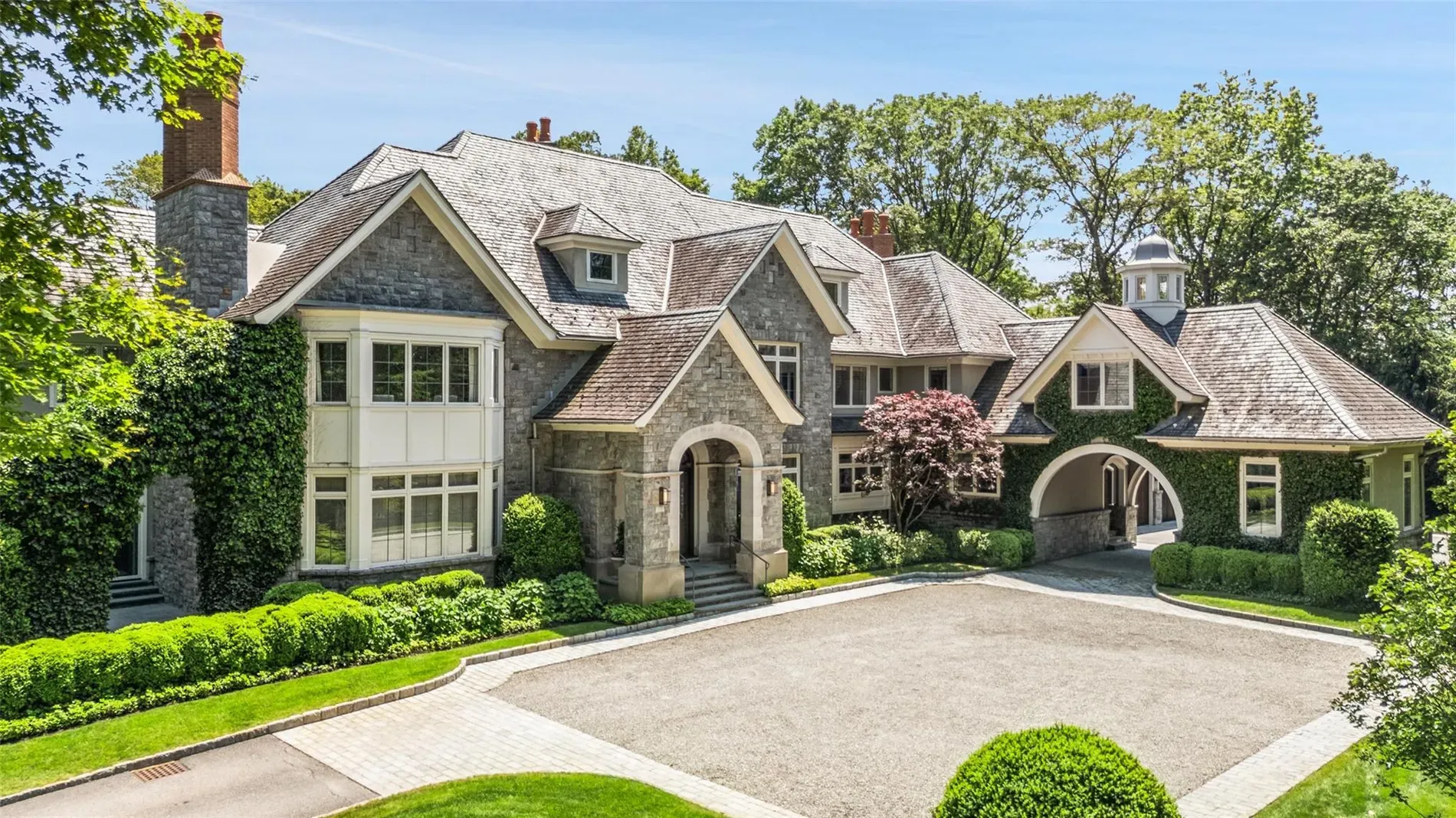 Here's the front—stone and white panels, super crisp. Landscaping is doing overtime.