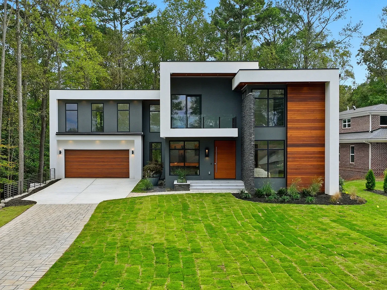 Charcoal and wood exterior looks sharp. Those huge front windows are doing work.
